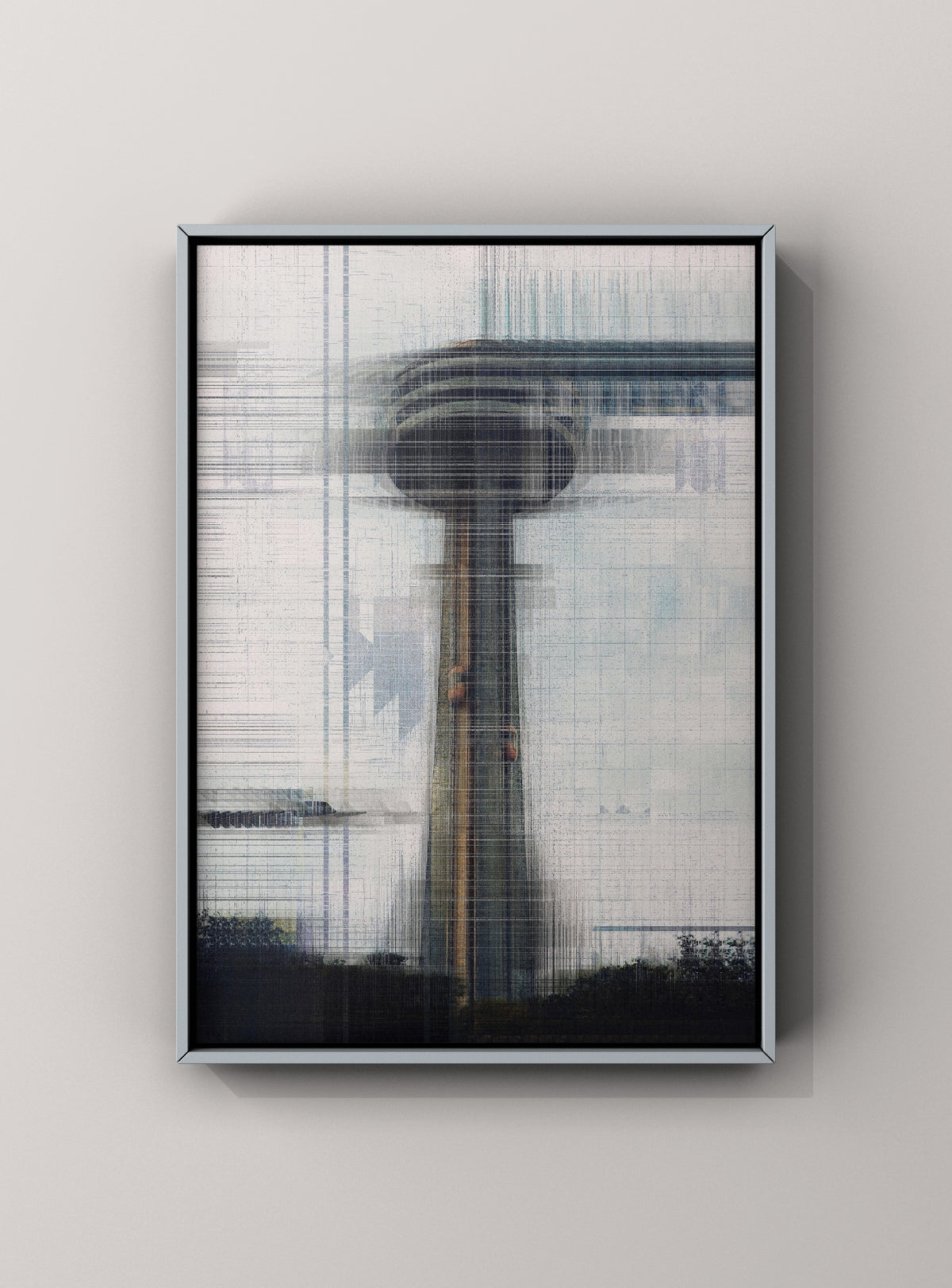 A framed abstract art print featuring a blurred tower-like structure in muted gray, white, black, and subtle blue tones, displayed against a light gray wall.
