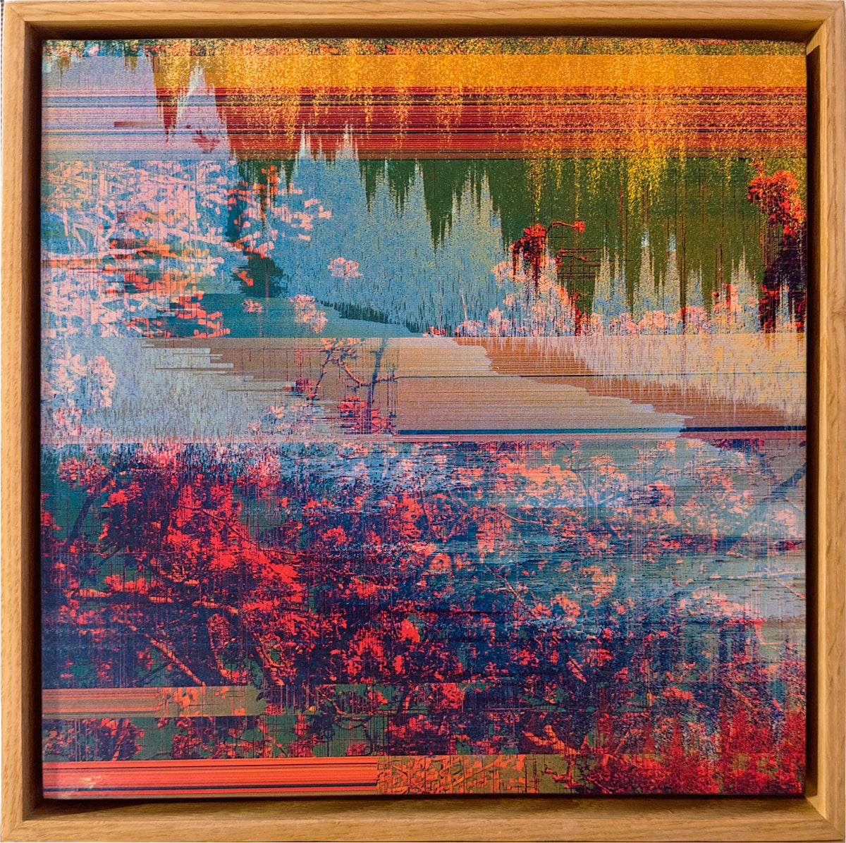 A framed abstract landscape painting featuring a reflective body of water with trees and foliage, rendered in a glitch-art style with horizontal distortion lines and vibrant red, blue, green, and orange tones, enclosed in a light wood frame.