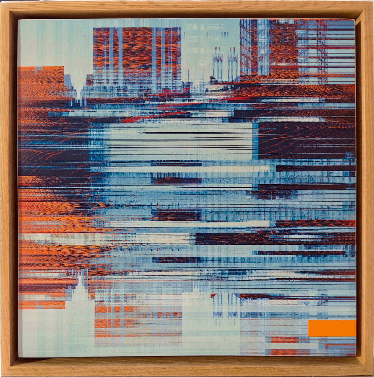 An abstract framed artwork featuring horizontal streaks and blocks of blue, white, orange, and dark red, with a light wood frame visible around the piece.